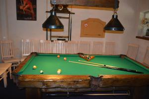 a room with a pool table with balls on it at Viesu nams Klāņas in Engure
