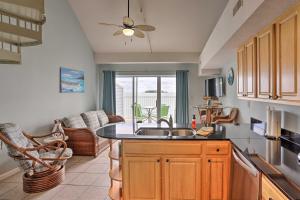 a kitchen with a sink and a living room at Resort-Style Condo with Lake-View Balcony! in Put-in-Bay