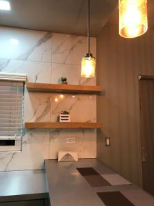 a kitchen with a counter and two pendant lights at Deluxe Apartment in Ensenada in Ensenada