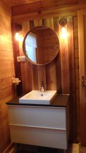 a bathroom with a sink and a mirror at Chalet Les Vosgiennes in Le Valtin +50 photos