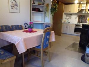 a kitchen and dining room with a table and chairs at Ferienhaus Weiherblick in Pottum