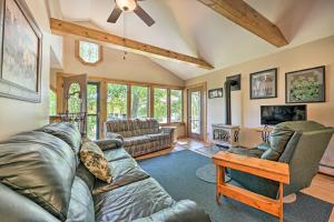 a living room with a couch and a table at Lakeside Iola Hideaway: Stunning Nature Views in Iola