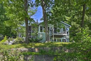 a house in the woods with trees at Lakeside Iola Hideaway: Stunning Nature Views in Iola