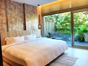 a bedroom with a large bed and a large window at JBG Hotspring Resort Hotel in Taipei