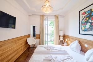 a bedroom with a white bed and white walls at Best Western Hotel Strasser in Graz