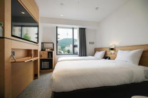 Krevet ili kreveti u jedinici u okviru objekta Henn na Hotel Seoul Myeongdong