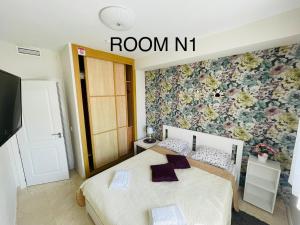 a bedroom with a bed with a room n sign at Marbella Deluxe Rooms in Royal Cabopino Townhouse in Marbella