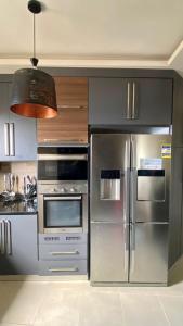 a kitchen with stainless steel appliances and a pendant light at Royal Luxury Apartment with Gorgeous Sea View in Alexandria