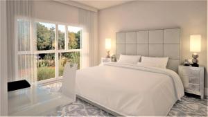 Ein Bett oder Betten in einem Zimmer der Unterkunft Royal Palm Hotel