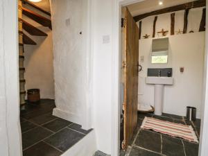 a bathroom with a toilet and a sink in a room at The Shippen in Rusland