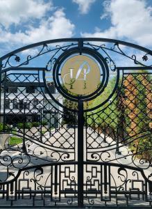 a wrought iron gate with a clock on it at Istanbul Park Hotel in Tuzla