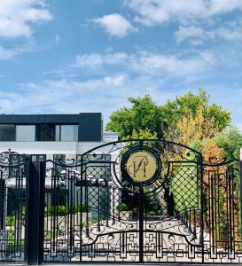 a clock on a gate in front of a building at Istanbul Park Hotel in Tuzla