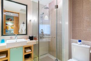 a bathroom with a shower and a sink and a toilet at Tianjin Crown International Apartment in Tianjin