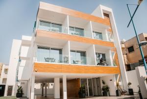 an apartment building with a large balcony at Caramela Luxury Apts in Ayia Napa