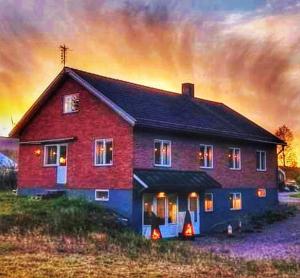 a painting of a house with lights on at Villa Vasa Sälen Nedre lägenhet in Transtrand