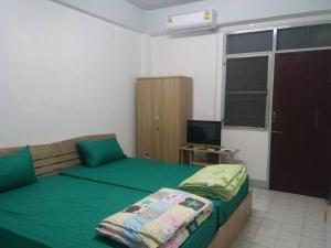 Natcha Place TU Rangsit客房内的一张或多张床位