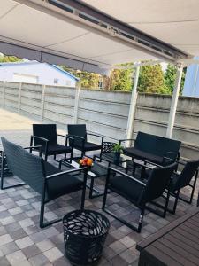 a group of chairs and tables on a patio at Penzión Pohoda in Nové Zámky