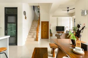 a living room with a wooden table and a couch at Mini House B&B in Luodong