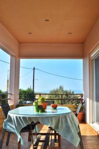 a table and chairs on a balcony with a view at Fully renovated apartment-ανακαινισμένο διαμέρισμα in Paradeísion
