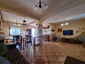 a large room with a kitchen and a living room at Дом для семейного отдыха в Утехе, Черногория in Utjeha