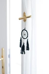a clock hanging from a door with bells at Lechner4 Residence in Szeged