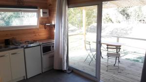 馬賽的住宿－Le chalet de La Treille，一个带桌子的厨房和一个带桌子的阳台