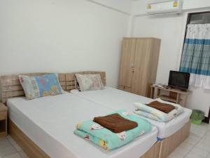 Natcha Place TU Rangsit客房内的一张或多张床位