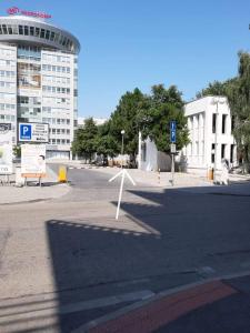 an empty street in front of a large building at Living Bratislava & Bus Station & Mlynské Nivy in Bratislava