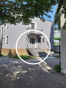 a white building with a white circle on it at Living Bratislava & Bus Station & Mlynské Nivy in Bratislava