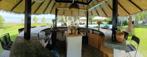 a bar in a restaurant with a view of the ocean at Beachfront Pool Villa and Apartment in Ko Chang