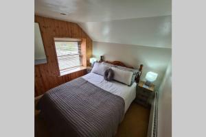 a bedroom with a bed with a teddy bear on it at North Lea charming cottage in stunning Staithes in Staithes