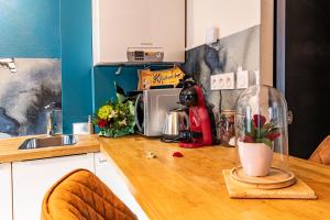 a kitchen with a counter top with a microwave at "Glamappartspa" So cosy Champagne offert & Parking in Dijon