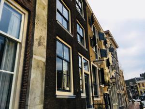 a brick building with windows on a street at StudioPlus in Dordrecht