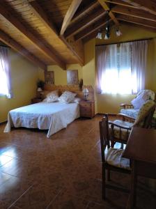 a bedroom with a large bed and two windows at El Mirador de Cercedilla - Nueva Apertura in Cercedilla