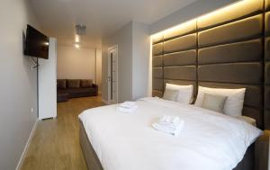 Postel nebo postele na pokoji v ubytování Residente Centr Apart-Hotel