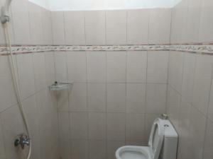 een witte badkamer met een toilet en een wastafel bij Modern Indekos Cilegon Syariah RedPartner in Grogol