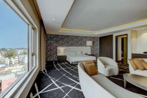 a hotel room with a bed and a large window at Radisson Blu Lagos Ikeja in Lagos