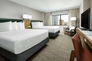 a hotel room with two beds and a flat screen tv at Hyatt Regency Bethesda near Washington D.C. in Bethesda