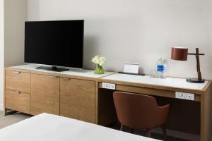 a desk with a television on top of it at Hyatt Regency Bethesda near Washington D.C. in Bethesda