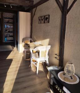 a room with a table and chairs in a room at Les Arpents Verts in Momignies
