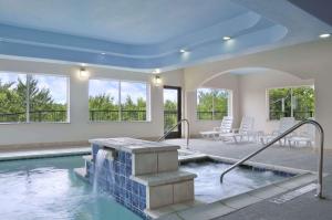 a swimming pool in a house with a swimming pool at Ramada by Wyndham South Waco in Hewitt