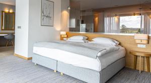 Hotel Marina Club في أولشتين: غرفة نوم بسرير كبير في غرفة