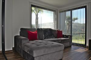 ein Wohnzimmer mit einem Sofa und einem großen Fenster in der Unterkunft Quinta dos Lagos in Marco de Canavezes