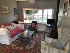 a living room with a couch and a table at Croagh Patrick Lodge Apartment in Westport