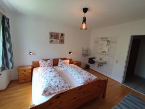 a bedroom with a bed with two pillows and a sink at Haus AlpenHahn in Wenns