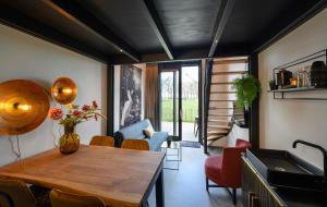 a kitchen with a wooden table and chairs in a room at Onder de Molen in Garderen +25 photos