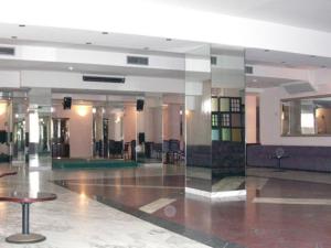 a large empty lobby with a table in a building at Hotel Excelsior in Latina