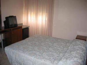 Ένα ή περισσότερα κρεβάτια σε δωμάτιο στο Hotel Excelsior