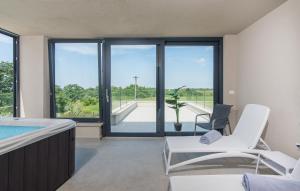 a living room with a tub and a table and chairs at Villa Colonia in Brtonigla