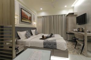 Letto o letti in una camera di Hotel Elysian Residency